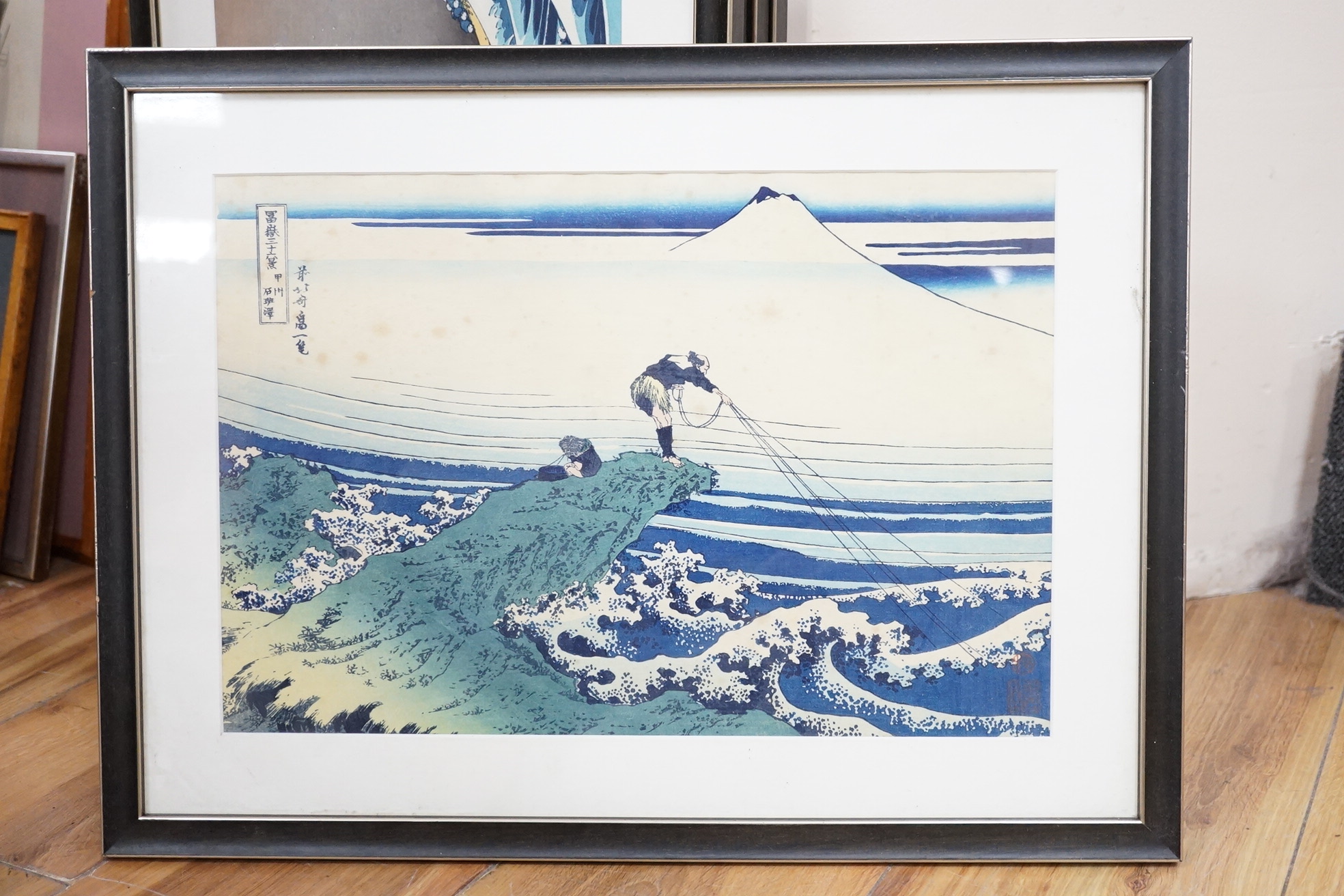 A set of ten Japanese woodblock prints to include ‘Great wave off the coast of Kanagawa’, ‘Fishermen at Kajikazawa’ and ‘Evening shower’, largest 25 x 36cm. Condition - fair